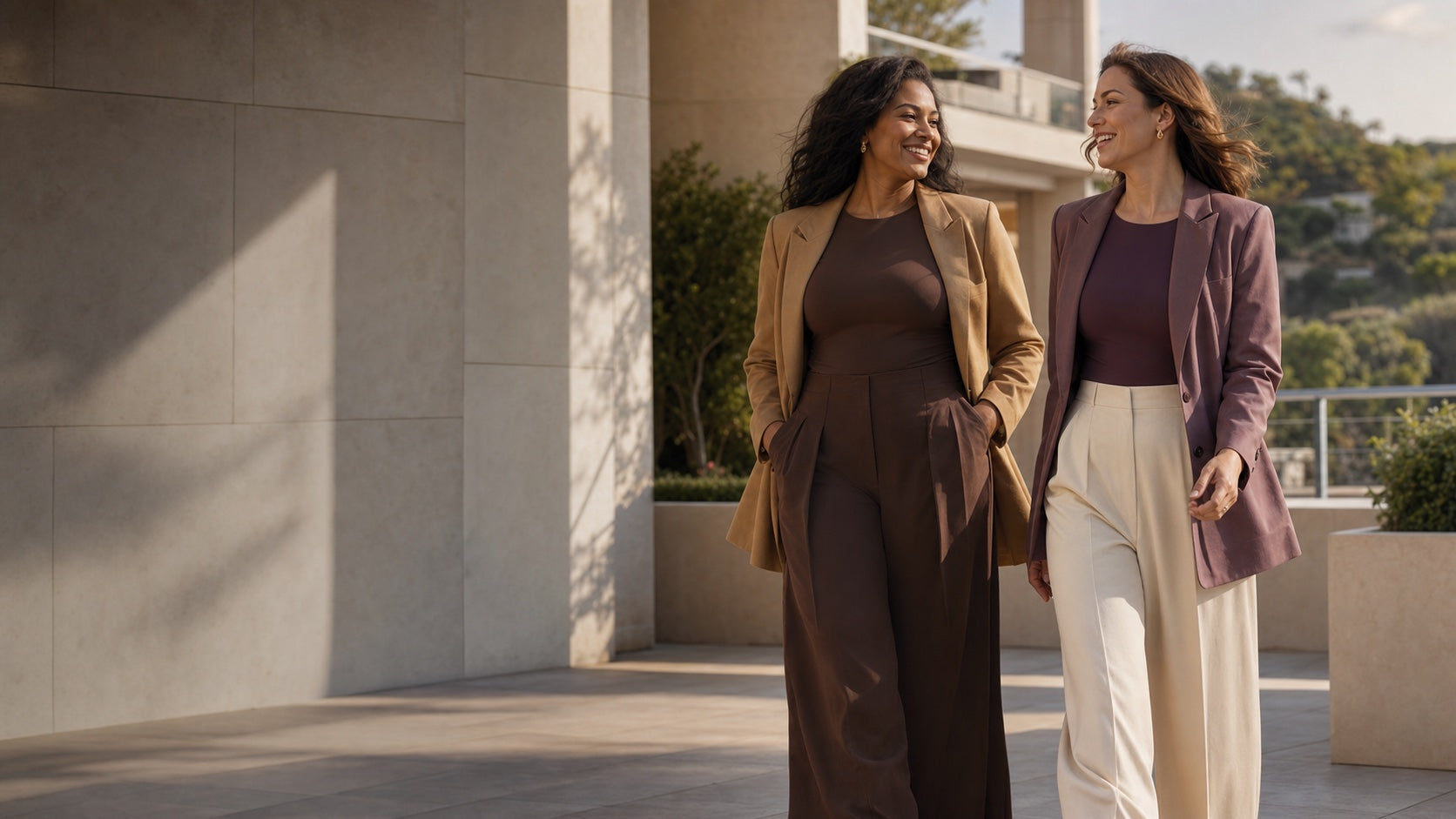 Two women moving confidently in polished NINONERA everyday layers